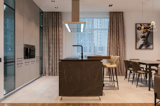 A modern kitchen with a dark brown island and chairs.