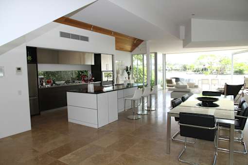 A modern kitchen with a dining table and chairs.