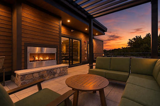 A modern house with a stone fireplace and a wooden table.