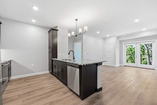 A modern kitchen with a large island and stainless steel appliances.
