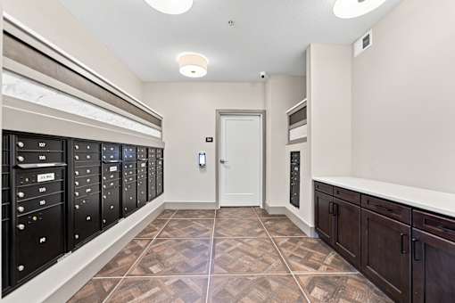 A hallway with a tiled floor and a white door.