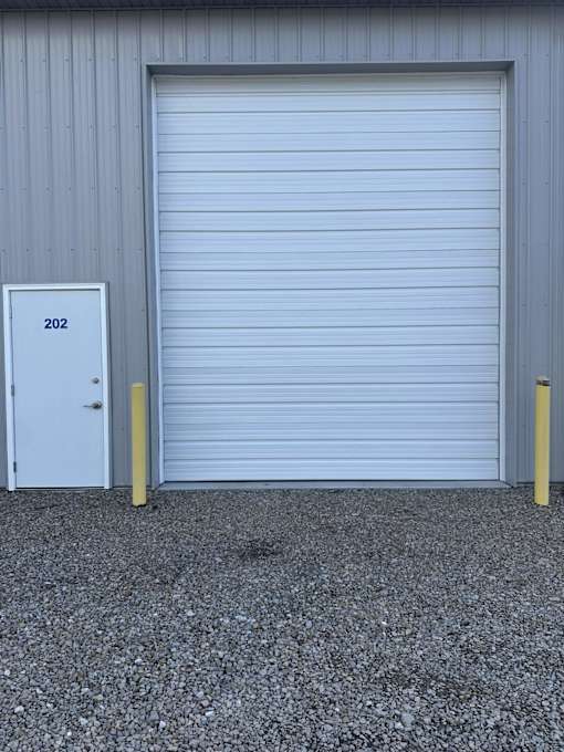 A white door with the number 202 on it is closed.