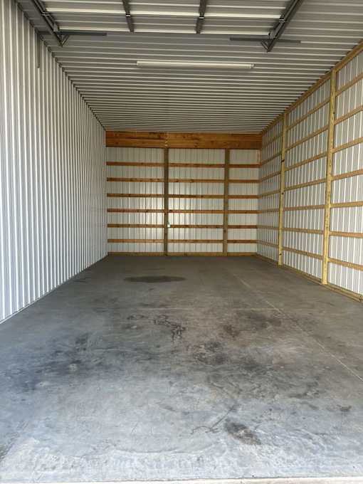 The inside of a storage container with a grey floor and a white ceiling.
