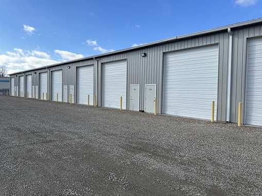 A long row of storage units with closed grey doors.