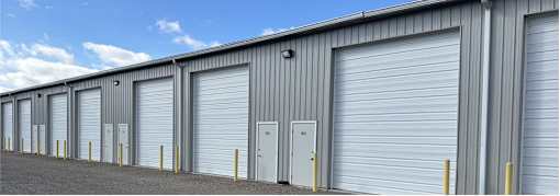A row of metal garage doors are closed.