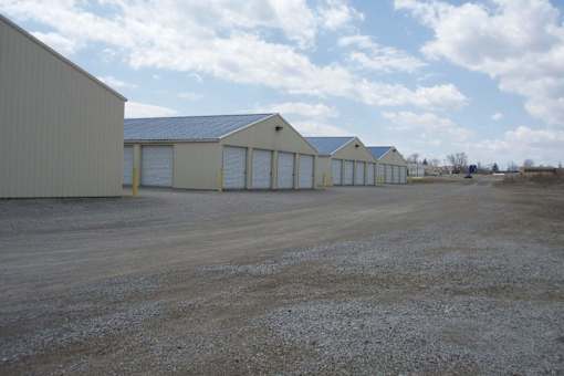 A row of garages are lined up in a field.