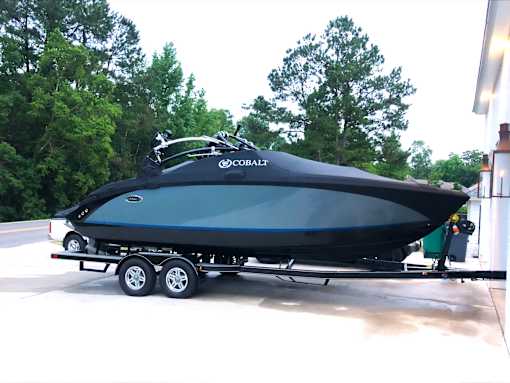 A black Cobalt boat is on a trailer.