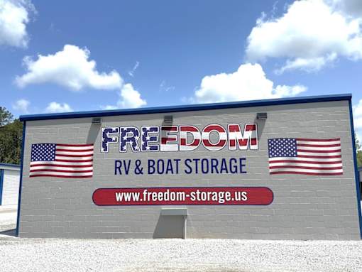 A building with a sign that says Freedom RV & Boat Storage.