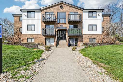 A building with a balcony and a walkway in front at Grand Valley Apartments, Ohio, 46150