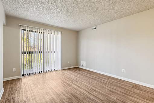 A room with a sliding door and wooden flooring  at Grand  Valley Apartments, Milford, OH, 46150