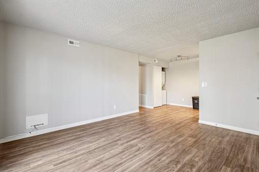 A room with wooden flooring and white walls  at Grand  Valley Apartments, Milford, Ohio