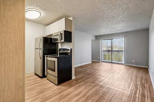 A kitchen with wooden floors and black appliances  at Grand  Valley Apartments, Milford, Ohio, 46150
