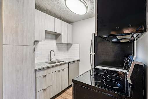 A kitchen with a black stove top oven at Grand  Valley Apartments, Milford, Ohio