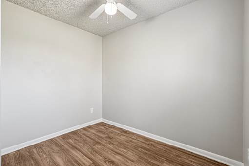 A room with a ceiling fan and wooden flooring at Grand  Valley Apartments, Milford, Ohio