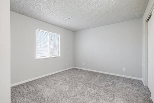 A room with a carpeted floor and a window at Grand  Valley Apartments, Milford, Ohio, 46150