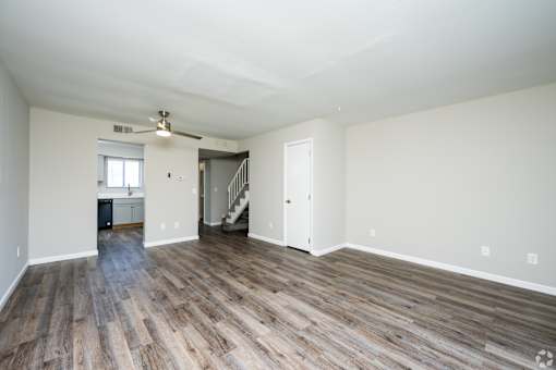 A room with wooden floors and white walls.