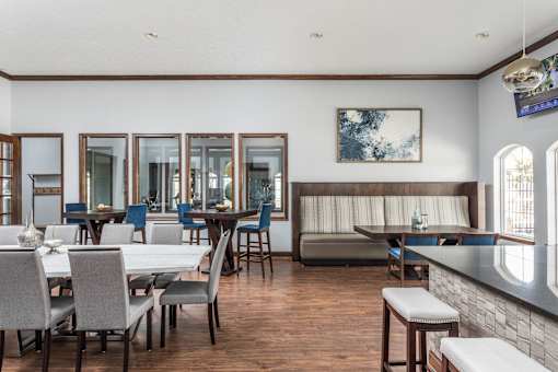 A dining room with a long table and chairs.