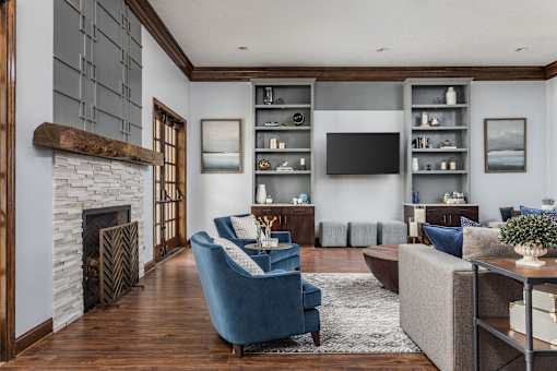 A living room with a fireplace and a blue chair.