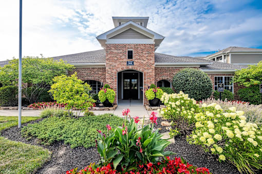 A house with a brick facade and a garden in front.
