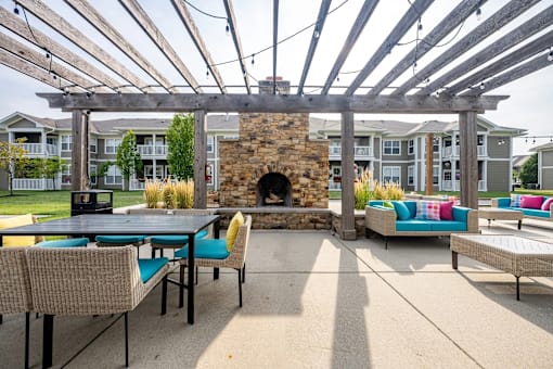 A patio with a fireplace and seating area.