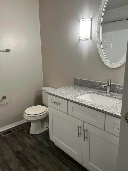 Bathroom with granite counter tops and a large mirror at Black Hawk Apartments, Fort Wayne, Indiana