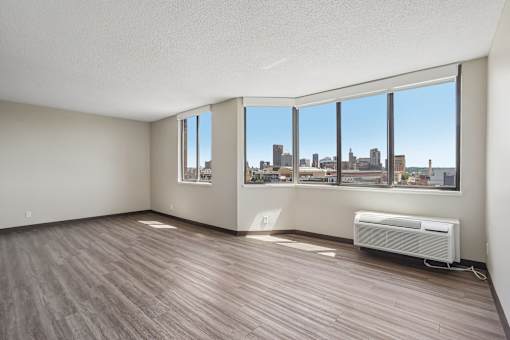 Irvine Park Towers apartment living room with expansive windows and views of St. Paul