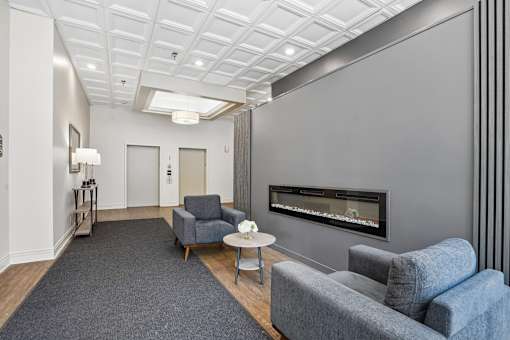 Resident lounge with seating and fireplace at Irvine Park Towers