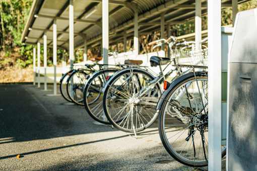 A row of bicycles are parked in a bike rack.