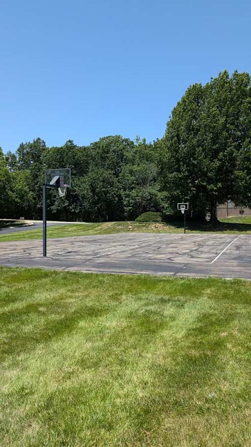 A basketball court with two basketball hoops.