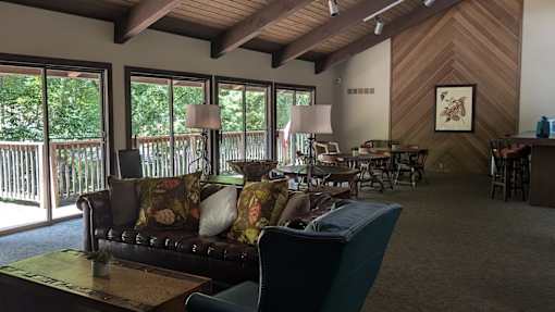 A living room with a couch, chairs, and a coffee table.