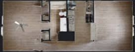 A top view of a room with a bed, a desk, and a chair.