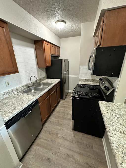 A kitchen with a black fridge and stove.