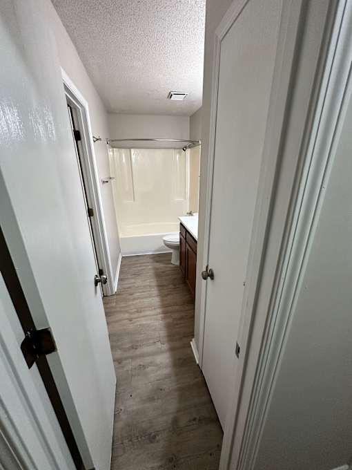 A white door with a black handle is on the left.