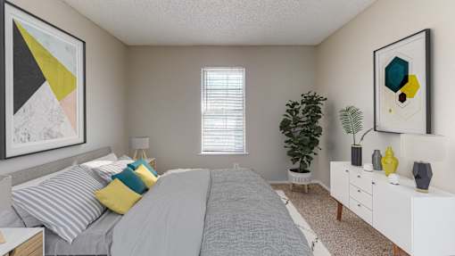 A bedroom with a bed, nightstand, and a dresser.