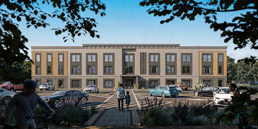 A modern building with a parking lot in front of it.