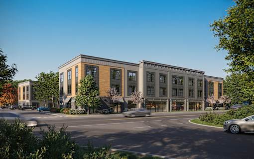 A modern building with a parking lot in front.