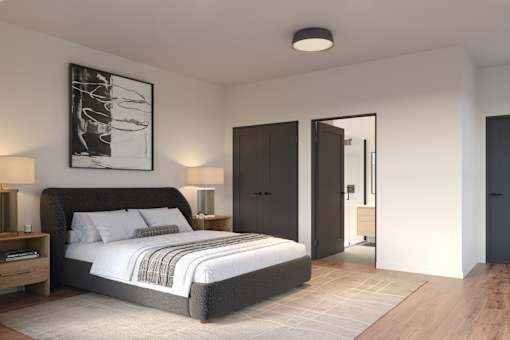 A modern bedroom with a large bed and a painting on the wall.