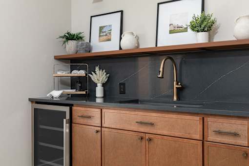 A kitchen with wooden cabinets and a black countertop.