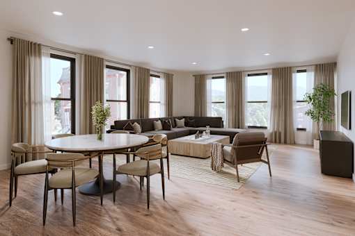 A modern living room with a large table and chairs.