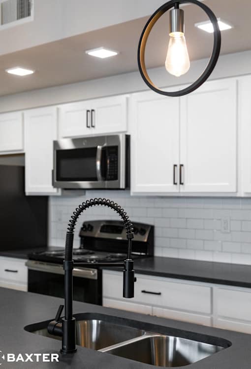 A modern kitchen with a black and white color scheme.