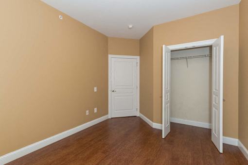 A room with a white door and a white closet door.