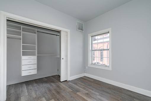 A room with a sliding door and a window.