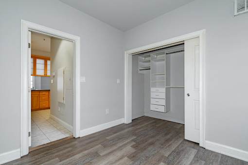 A room with a white door and a white wall.