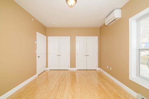 A room with a window and a white door.