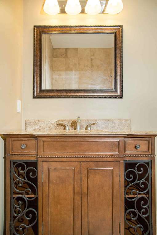 A bathroom vanity with a mirror and lights above it.