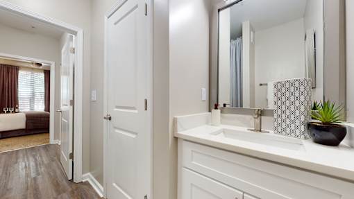 A bathroom with a white sink and a mirror at Embry Hills, Atlanta, 30042
