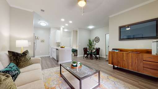 A living room with a couch, coffee table, and a television at Embry Hills, Atlanta, Georgia