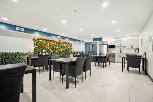 A dining area with a Christmas wreath on the wall.