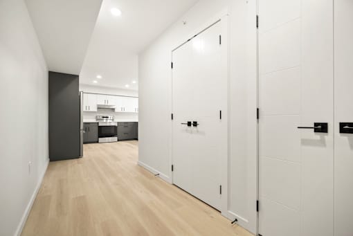 A white door with a black handle is on the right.