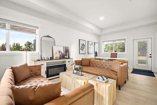 A living room with brown leather couches and a wooden coffee table.